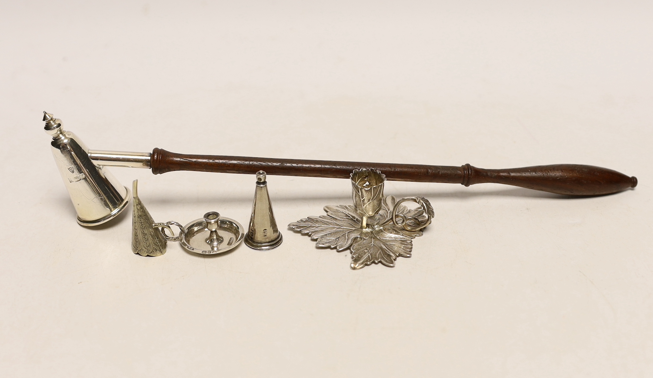 A George IV silver chamberstick, of leaf form, Birmingham, 1829, with associated unmarked extinguisher, together with a late Victorian miniature silver chamberstick, by William Comyns, retailed by Child & Child, a modern